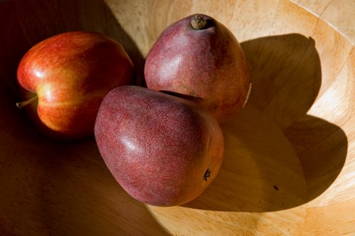 Red Fruit in a Wooden Bowl